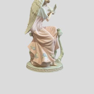 Members mark hand-painted porcelain angel figurine