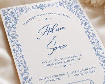 Peut inclure: Une carte d'invitation de mariage blanche avec une bordure florale bleue et du texte bleu indiquant : Together with their families, Adam & Sara, invite you to celebrate their love and union, Sat, Oct 12th 2026 at 4:00 PM, 1234 Willow Lane, United States.