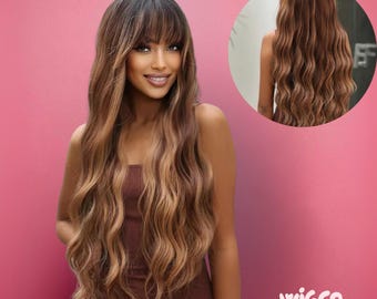 May include: A woman with long, wavy, brown and blonde hair with bangs. The hair is styled with loose waves and a natural-looking color gradient. The image also includes a smaller inset showing the back of the hair. The wigco logo is in the bottom right corner.