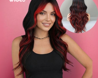 May include: A long wavy wig featuring a black base colour with vibrant red highlights framing the face and throughout the lengths. The wig has a centre part and soft waves. The brand name WIGCO is printed in white text in the upper left corner.
