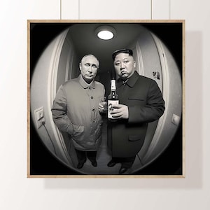 May include: Monochrome framed print showing two men in coats, one holding a bottle. The image is captured with a fisheye lens, producing a distorted view. The print is hung on a white wall.