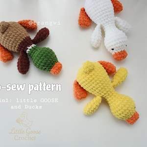 May include: Crocheted duck and goose toys in brown, white, and yellow with orange accents. The toys are lying on a white surface. The text "No-sew pattern" and "3in1: little GOOSE and Ducks" is visible.