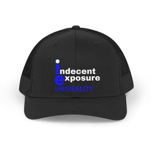 Puede incluir: Gorra de camionero negra con parte trasera de malla y visera curva. La parte delantera muestra el texto "indecent exposure UNIVERSITY" en blanco y azul, con un pequeño punto azul encima de la "i" y una "e" azul.