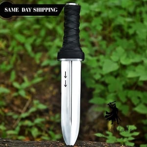 May include: A silver dagger with a black wrapped handle. The blade has two arrows pointing down. The text "Forged Blade" is at the bottom right. The text "SAME DAY SHIPPING" is at the top left.