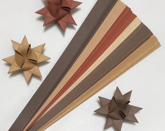 May include: A set of 12 paper strips in various shades of brown, beige, and red. The strips are arranged in a fan shape, with the darkest shades at the bottom and the lightest shades at the top. The strips are perfect for paper crafts, origami, and other creative projects.
