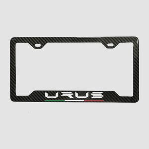 May include: Black carbon fiber license plate frame with the word "URUS" in white letters. The frame has a woven texture and features the Italian flag colors: green, white, and red.