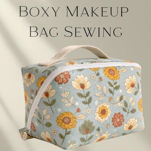 Pode incluir: Bolsa de maquilhagem quadrada com um padrão floral em tons de amarelo, laranja e verde sobre um fundo azul claro. Tem um fecho branco e uma pega a condizer. O texto "Boxy Makeup Bag Sewing" está no topo.