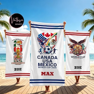 May include: Three white beach towels featuring FIFA World Cup 2026 graphics. The towels display soccer imagery, national symbols, and the text Canada USA Mexico World Cup 2026, with the personalized names Zoe and Max printed in bold black letters.