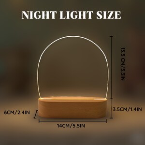 May include: A night light with a wooden base and a curved, illuminated top. The dimensions are 14 inches wide, 5.3 inches tall, and 2.4 inches thick. The text "NIGHT LIGHT SIZE" is at the top.