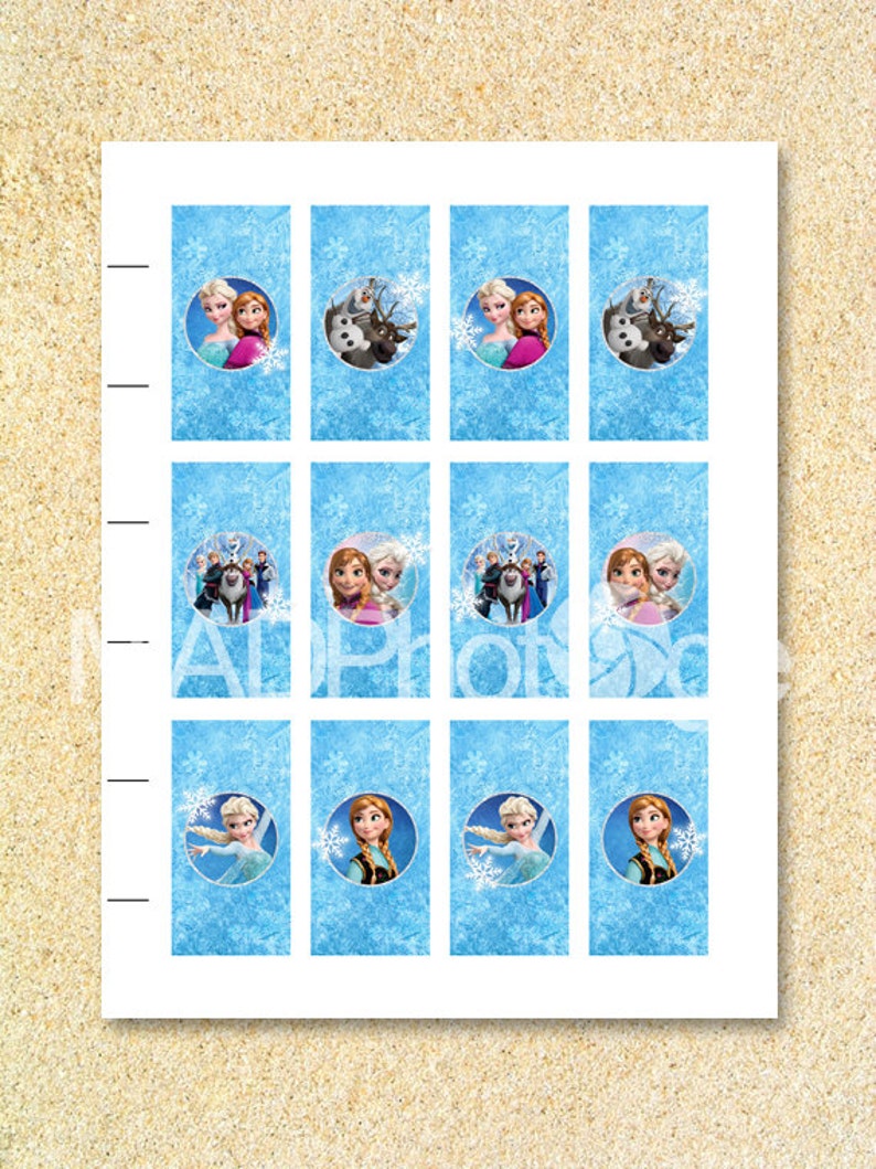 May include: A sheet of paper with twelve rectangular images featuring characters from the animated film "Frozen." Each image has a blue background with snowflakes and a circular image of Elsa, Anna, Olaf, and Sven.
