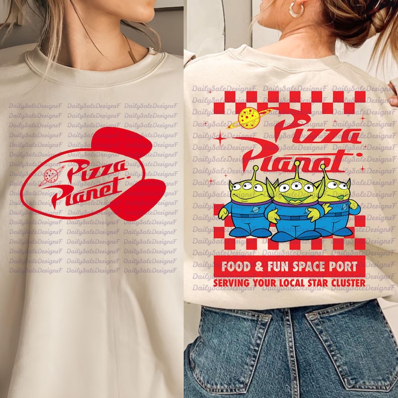 May include: Off-white sweatshirt featuring the "Pizza Planet" logo in red and white. The design includes a red oval with the text "Pizza Planet" and a cartoon image of three green aliens in blue spacesuits. The text "FOOD & FUN SPACE PORT" is also visible.