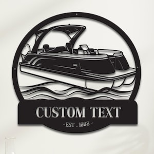 May include: Black metal wall art depicting a pontoon boat within a circular frame. The boat is shown on stylized water waves. A banner below the boat reads "CUSTOM TEXT" and "-EST. 1998-".