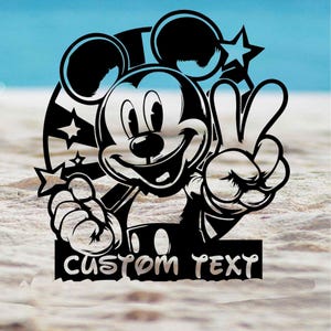 May include: Black and white Mickey Mouse design giving a peace sign. The design features stars and a striped background. The words "CUSTOM TEXT" are at the bottom. The image is set against a blue sky and sand background.