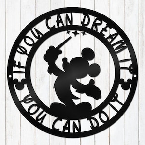 May include: Black metal wall art featuring Mickey Mouse holding a wand inside a circular frame. The text "IF YOU CAN DREAM YOU CAN DO IT" is inscribed around the circle. The design includes Mickey Mouse silhouettes and star accents.