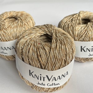 May include: Three balls of beige and brown jute cotton yarn with the label "KnitVaana Jute Cotton" on each ball.