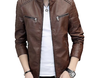Puede incluir: Chaqueta de cuero marrón con cuello alzado y detalles acanalados en los hombros. Cuenta con dos bolsillos con cremallera en el pecho y cierre de cremallera frontal. La chaqueta es de color marrón liso y tiene un diseño clásico y elegante.