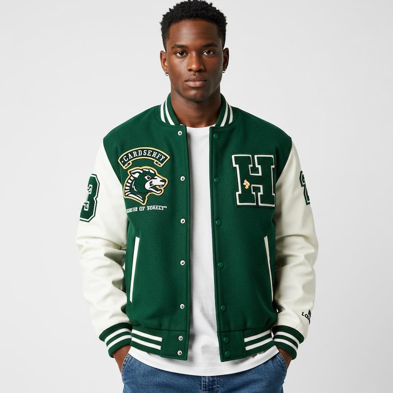 May include: Green and white varsity jacket with a button-up front. The jacket features a large "H" patch, a patch with a bear graphic, and the number "3" on the sleeve. The jacket has white sleeves and green body with white stripes on the collar, cuffs, and hem.