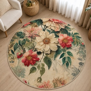 May include: A round area rug featuring a botanical print with large, detailed flowers in shades of cream, soft pink, and deep red. The design includes dark green foliage and intricate, faded script-like patterns on a light beige background.