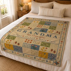 May include: A cream-colored throw blanket featuring a patchwork design of floral, strawberry, and plaid squares. The text GRANDMA We love you is printed in the center, followed by the names Laney, Joseph, Mary, and Jack separated by red hearts.
