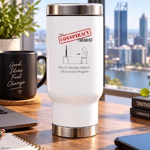 May include: A white travel tumbler with a silver lid and base. The front features a red stamp graphic reading "CONSPIRACY THEORIST" above a stick figure watching television, with the text "Bro, its literally called a Tell-a-Vision Program" below.