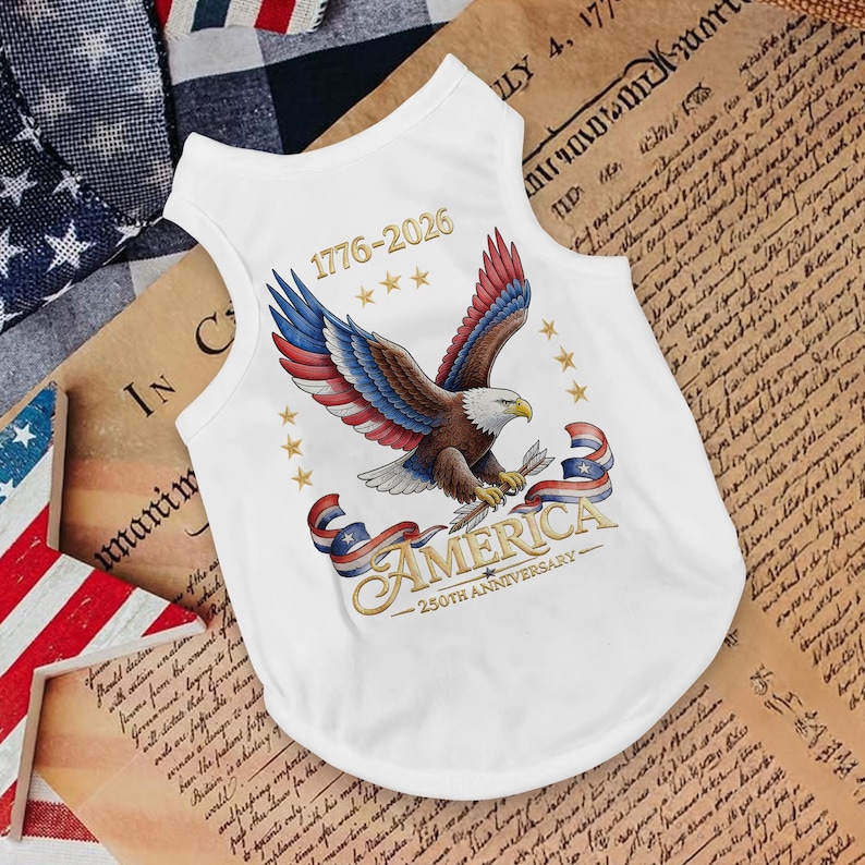 May include: White pet tank top featuring a patriotic design with a bald eagle, stars, and the word "AMERICA." The design includes the text "1776-2026" and "250th Anniversary." The tank top is made of a soft, lightweight material.
