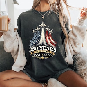 May include: A set of three ceramic mugs with a speckled, matte finish. The mugs are in shades of cream, light grey, and dark grey. Each mug has a simple, minimalist design, ideal for coffee or tea.