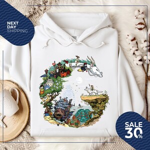 a white hoodie with a colorful illustration of a castle, dragon, and other fantastical elements, along with a sale sign indicating a 30% discount.