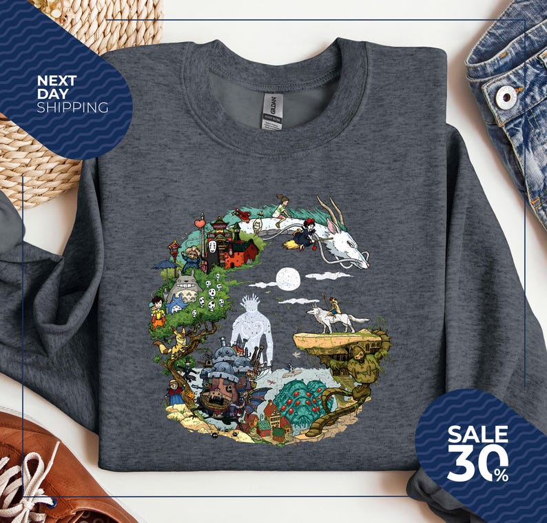a gray sweatshirt with a colorful graphic design depicting various characters and elements from the animated film "Spirited Away".