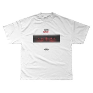 May include: White t-shirt featuring a graphic design. The design includes the words "FUTURE HONEST" in red above a rectangular image of a pair of eyes. Below the eyes is a small black box with white text.