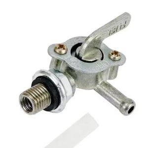 May include: A silver fuel valve with a lever marked "FUEL". The valve features a threaded end, a small tube, and is secured with two screws. A white plastic tube is visible.