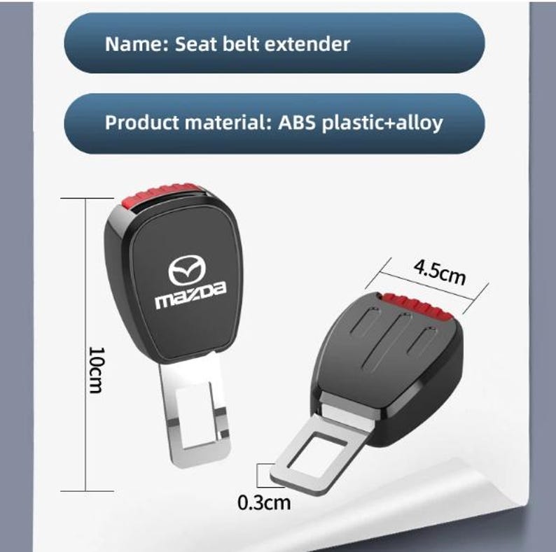 May include: Black seat belt extender with a red release button. The extender is 10 cm long and 4.5 cm wide, made of ABS plastic and alloy. The Mazda logo is visible on the front.