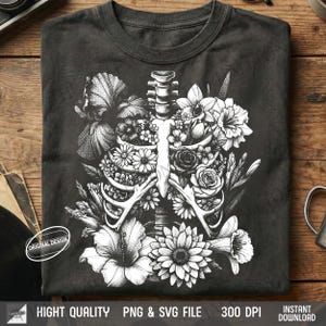 Dark grey t-shirt flat lay featuring a vintage halftone Skull with roses growing out, gothic valentine design.