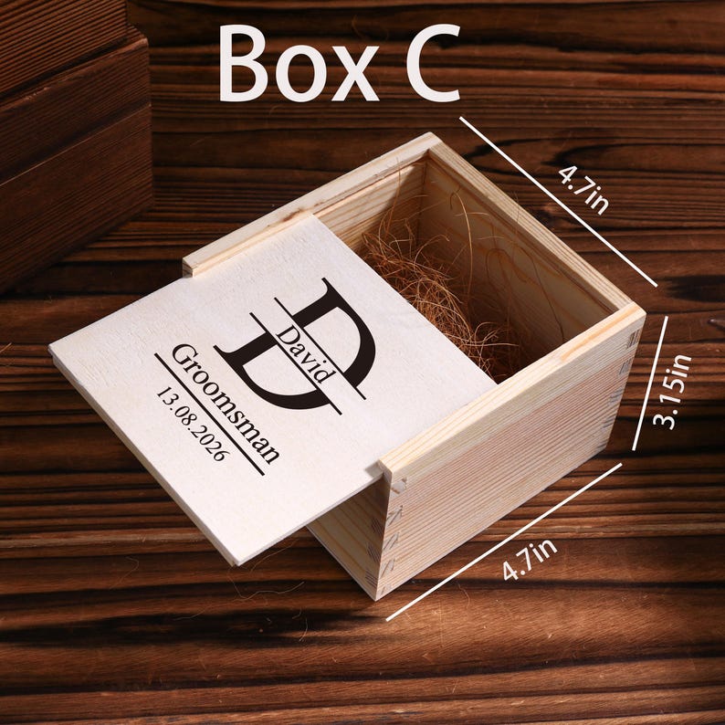 May include: A wooden box with a hinged lid, labeled "Box C." The lid is engraved with "David," "Groomsman," and the date "13.08.2026." The box measures 4.7 inches by 3.15 inches. The box is filled with decorative straw.
