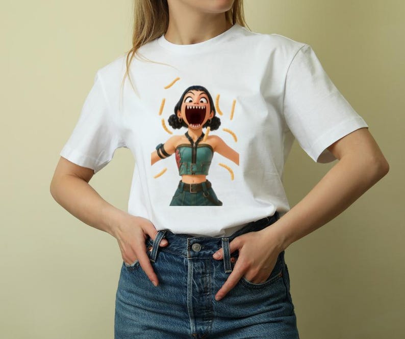 May include: White t-shirt featuring a cartoon illustration of a woman with an open mouth and orange accents. The woman is wearing a teal top and dark green pants. The shirt is made of a soft, comfortable material.