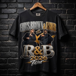 May include: Black t-shirt with a graphic design. The design features the text "CHRIS BROWN & USHER" above "the R&B 2026 Tour". The design includes images of Chris Brown and Usher in a vintage style.