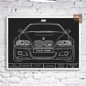 May include: A framed black and white blueprint of a BMW M3 E46 car. The print features the text "YOUR NAME" on the front, along with technical details and the "M" logo. The frame is white.