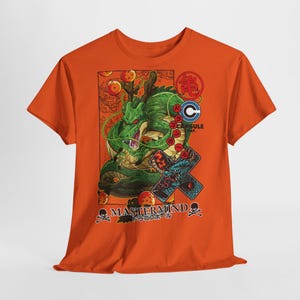 May include: Orange t-shirt featuring a green dragon illustration with the text "MASTERMIND" and Japanese text. The design includes dragon balls, a Capsule Corp logo, and a blue dragon graphic.