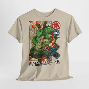 May include: A beige t-shirt featuring a green dragon illustration with the text "MASTERMIND" and Japanese text. The design includes orange orbs, a Capsule Corp logo, and a dragon graphic on a cross.