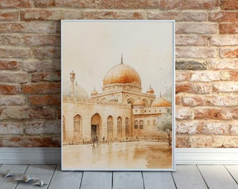 May include: Watercolour painting of a mosque with a large golden dome and several smaller domes. The building is beige with arched doorways and windows. The artwork is framed in a white border and leans against a brick wall.