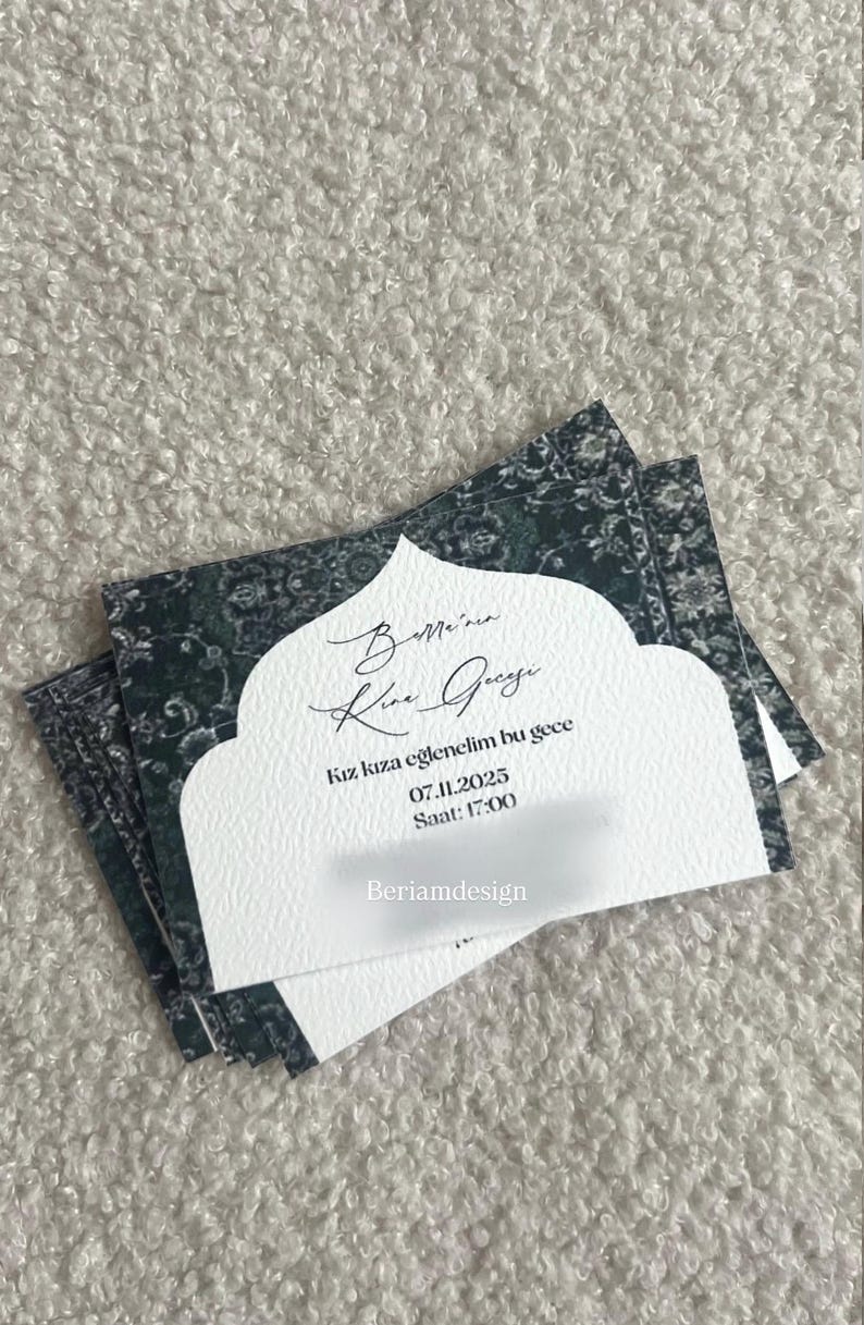 May include: Stack of invitation cards with a white textured front and a dark green patterned back. The front of the card has text in a script font. The text includes the date 07.11.2025 and time 17:00.
