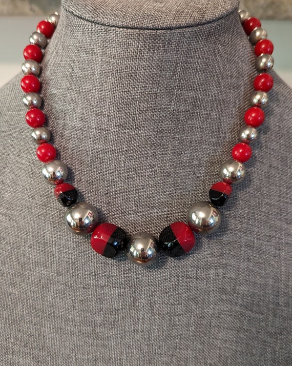 Hobe laminated black and red Bakelite, chrome bead