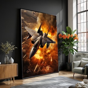 Pode incluir: Impressão emoldurada de um caça em voo, contra um fundo de explosões e fumo. A aeronave é cinza com asas detalhadas e um cockpit. A obra de arte é exibida em uma sala de estar moderna.