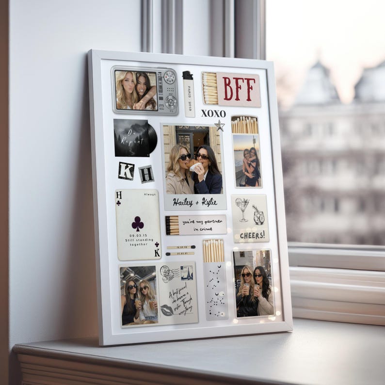 May include: A white framed collage featuring multiple photos and decorative elements. The collage includes photos of friends, the letters "BFF" and "XOXO", playing card imagery, and the words "Cheers!" and "Hailey + Kylie". The collage is displayed on a windowsill.