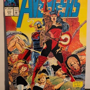 May include: Avengers comic book cover featuring a dynamic illustration of costumed heroes in action. The cover displays the title "Avengers" in large, blue letters, with several figures in vibrant costumes. The comic is labeled "373" and "APR".