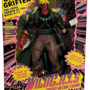 May include: A WildC.A.T.S. Giant Grifter action figure in its original packaging. The figure is 10 inches tall and features a red mask, green jacket, and brown pants. The packaging includes text such as "Collector's Edition" and "Giant High Tech Action Accessories!"