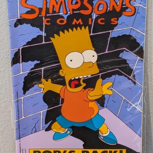 May include: A Simpsons Comics issue number 2 comic book featuring Bart Simpson on the cover. The cover art shows Bart in an orange shirt and blue shorts against a blue brick wall with a black shadow. The text reads Simpsons Comics, Bob's Back!
