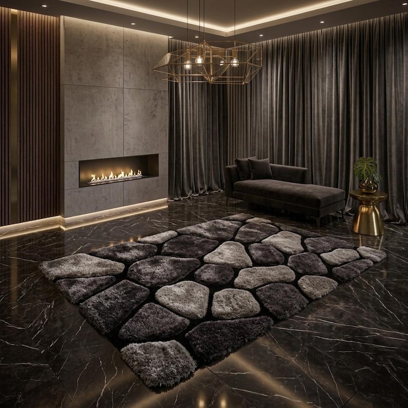 May include: A rectangular area rug featuring a textured, shaggy pile with a pattern of irregular, stone-like shapes in varying shades of charcoal, slate grey, and light silver, arranged to resemble a mosaic of river rocks on a dark floor.