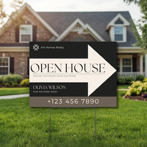 May include: An open house sign on a grassy lawn in front of a house. The sign has a black background with a white arrow and the words "OPEN HOUSE." Below the text is the name "OLIVIA WILSON" and a phone number.