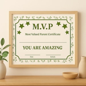 May include: A framed certificate with the text "M.V.P Most Valued Parent Certificate" in green. The certificate has a beige background with green star and floral accents. The text "YOU ARE AMAZING" is also in green.