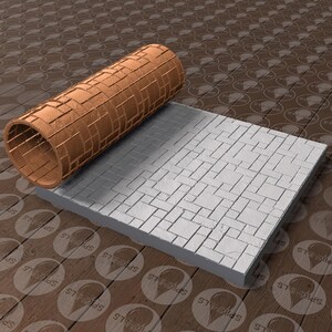 May include: A copper-colored cylindrical roller and a rectangular gray block, both with a brick pattern. The roller is positioned above the block, suggesting a tool for imprinting textures. The background is a wooden surface.
